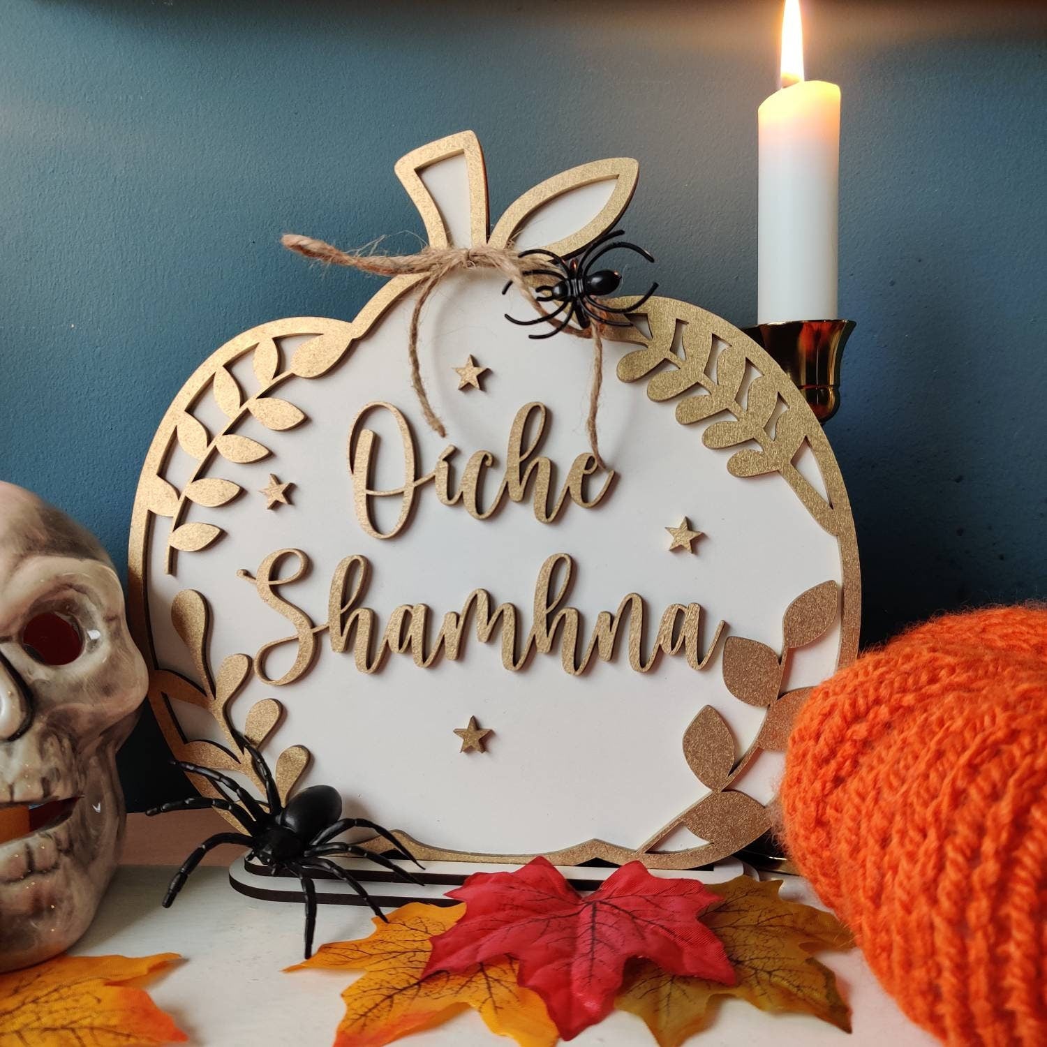 Image of a personalized Halloween family pumpkin plaque. The plaque is made of wood and features a carved pumpkin with the Irish for "happy Halloween"